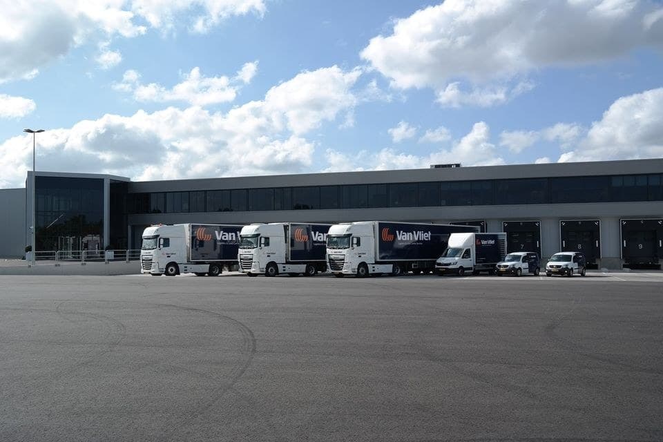Van Vliet distribution center in the Netherlands, branded trucks at the loading docks